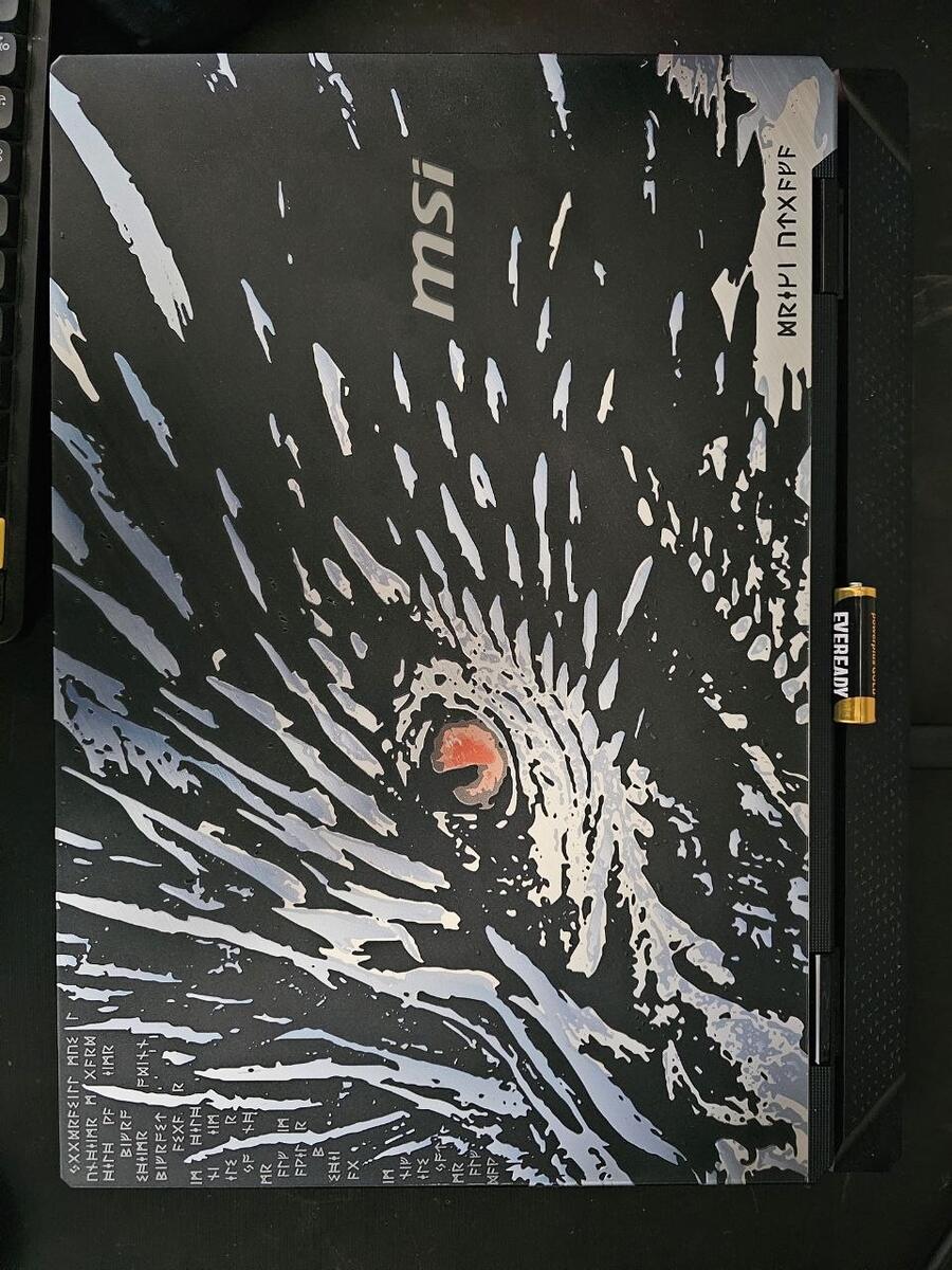 Embossed Norse dragon artwork on the closed MSI Titan laptop lid